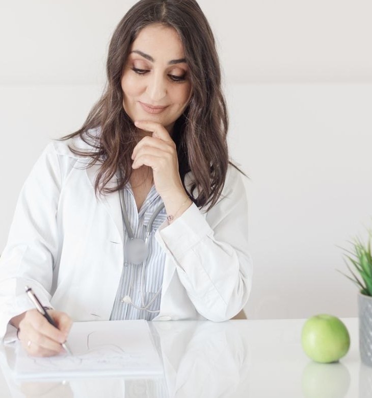 Nutrition consultation with a fresh green apple on the desk